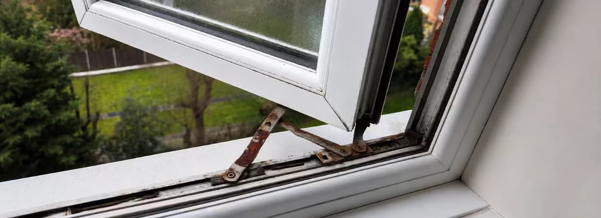 Rusted friction hinge on an open uPVC window