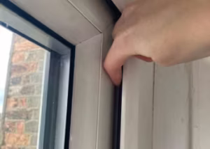 Removing dirt and rust from a stiff window hinge.